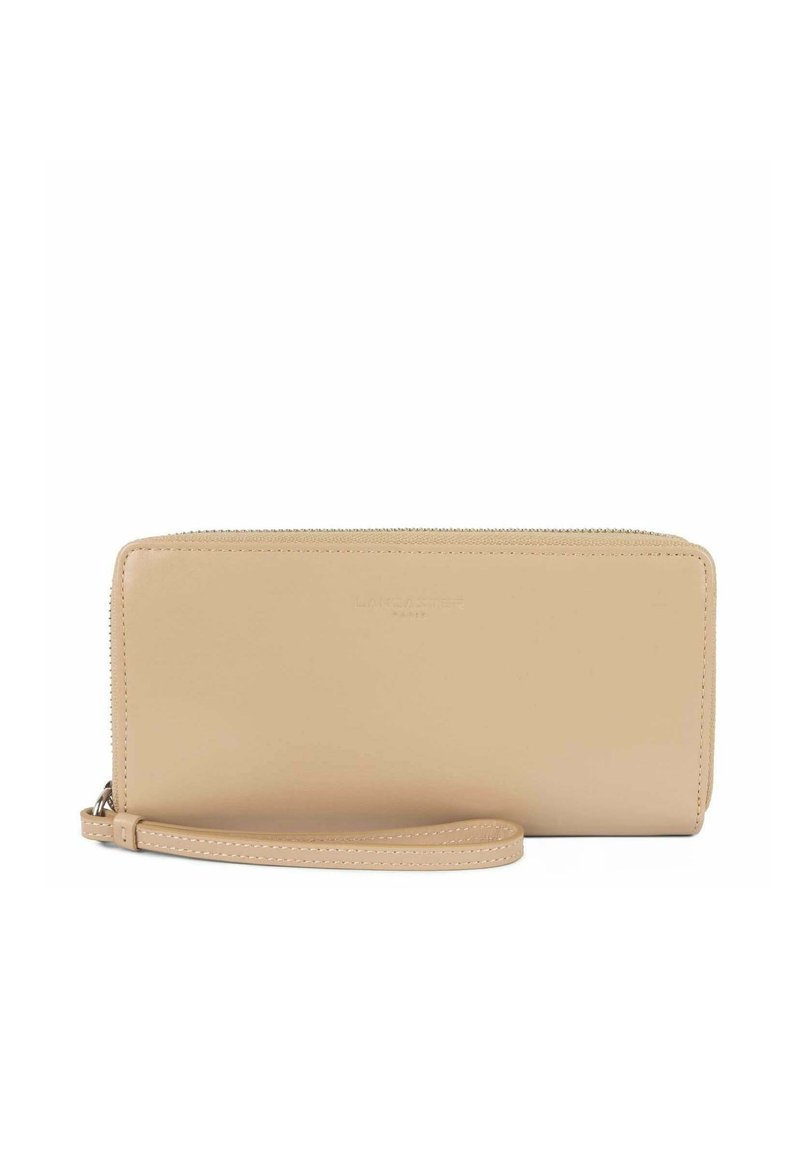 Portafoglio in pelle beige con chiusura a zip, dotato di un bracciale e logo impresso sottile. Texture liscia e forma rettangolare.