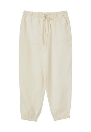 Cremefarbene, lässige Hose mit elastischem Bund und Kordelzug. Verfügt über zwei Fronttaschen und schmal zulaufende Bündchen. Glatte Textur.