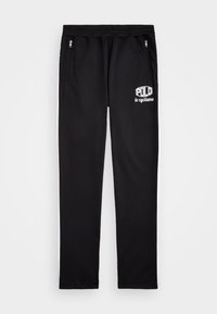 Mustat urheiluhousut, jotka on valmistettu sileästä kankaasta, ja joissa on kaksi vetoketjullista sivutaskua sekä valkoinen logo, jossa lukee "POLLO le cyclisme."