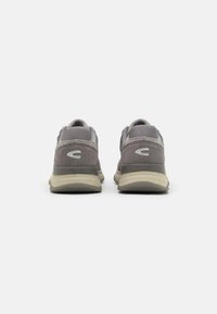 Gray athletic shoes featuring a mix of suede and mesh materials, with a padded collar, contrasting accents, and a rubber sole.
