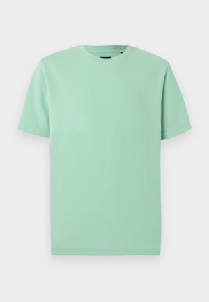 T-shirt uni à manches courtes et col rond en vert menthe clair, présenté sur un fond blanc.