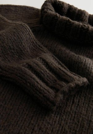Dark brown knitted sweater with a ribbed turtleneck and textured fabric, featuring chunky stitches and a soft, thick appearance.