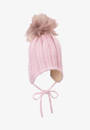 Pink knitted winter hat with ear flaps, braided cable pattern, faux fur pom-pom on top, and tied chin straps.