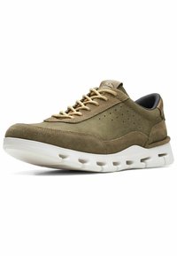 Olive green suede sneaker with gold laces, perforated detailing, textured accents, and a white cushioned sole featuring cutouts.