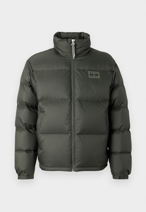 Grüne Puffjacke mit hohem Kragen, Frontreißverschluss, boxy Design und gesteppten Abschnitten. Mit einem kleinen Logodetail auf der oberen Brust.