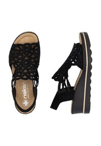 Sandales noires avec un design en crochet à l'avant, semelle rembourrée et semelle extérieure noire texturée. Logo de la marque présent sur la semelle intérieure.