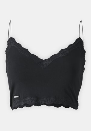 Svart cami med tynne stropper, med scallop-lace kant langs halsen og hem. Laget av mykt, elastisk stoff.