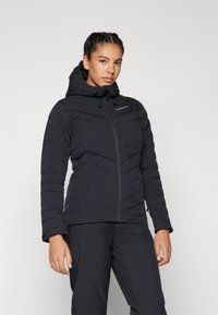 Black insulated jacket with a hood, featuring a front zipper, vertical quilting, and a fitted design. Lightweight fabric with a smooth texture.