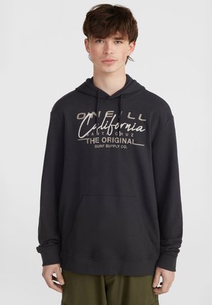 Black hooded sweatshirt made of soft fabric, featuring a front kangaroo pocket and cream lettering with brand name and location printed on the chest.