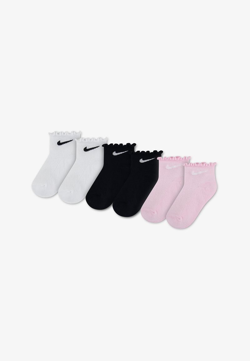 Τρία ζευγάρια κάλτσες αστραγάλου Nike σε λευκό, μαύρο και ροζ, το καθένα με βολάν στο πάνω μέρος και λογότυπο Nike swoosh κοντά στον αστράγαλο.