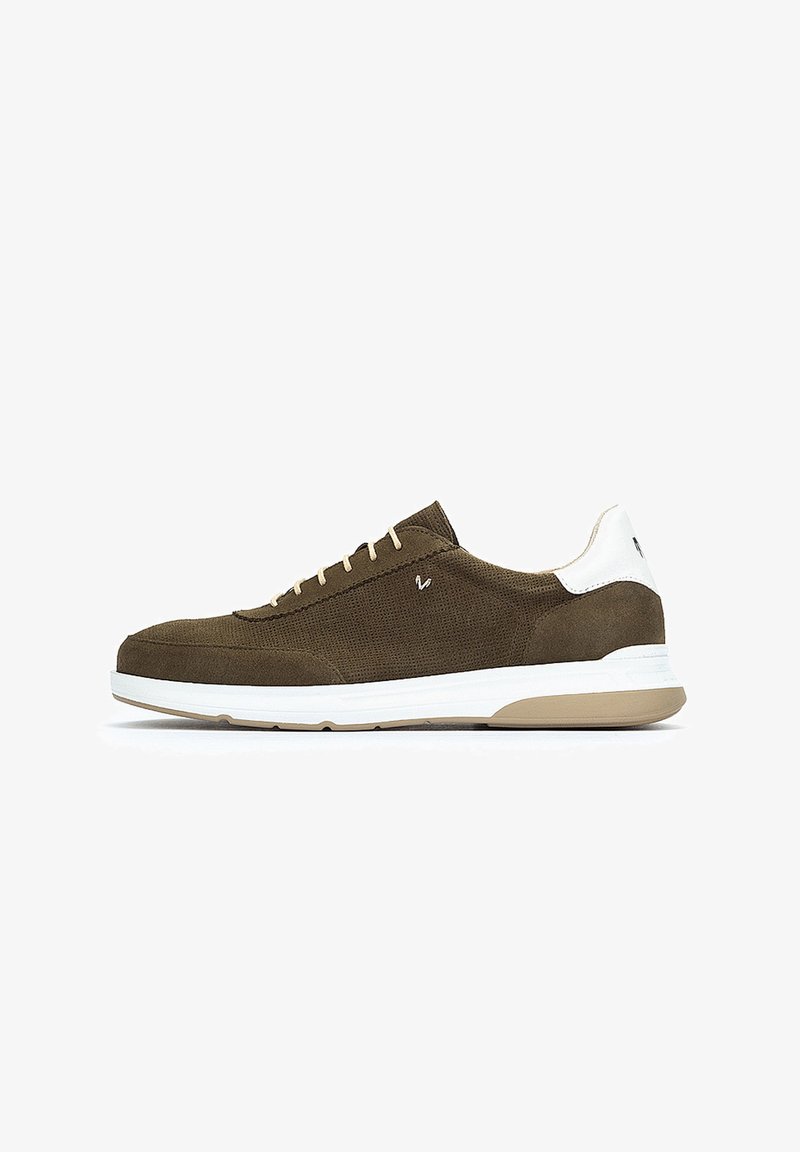Baskets en suede marron avec un talon blanc et une semelle beige. Elles sont équipées de lacets plats et d'une surface texturée, conçues pour le confort et le style.