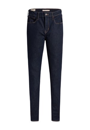 Dunkle Jeans aus Denim mit schmaler Passform, fünf Taschen-Design und Metallbeschlägen. Kontrastnaht entlang der Nähte und Knopfverschluss an der Taille.