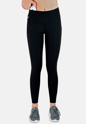 Black high-waisted leggings with a pocket, slim fit, stretchy fabric, and flat seams, paired with gray athletic shoes.