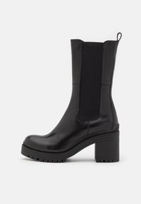 Black mid-calf leather boot with chunky block heel, elastic side panels, pull tab at back, and ridged rubber sole.