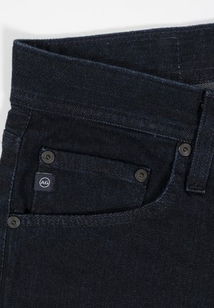Mørke denimjeans med rette ben, med en liten frontlomme, metallknapper og en logotag på midjen.