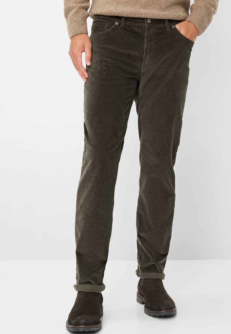 Donkergroene corduroy broek met een rechte snit, voorzien van een frontzak, opgerolde boorden en een gestructureerde stof. Gekocht met bruine enkellaarsjes.