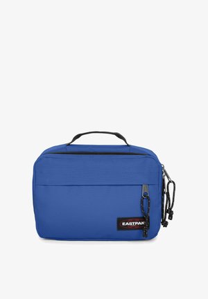 Pochette Eastpak bleue avec poignée noire et deux compartiments zippés, avec patch logo en bas à droite sur le devant.