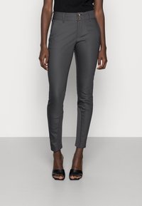 Gray fitted trousers with a smooth texture, featuring a button closure and two front pockets. Paired with black open-toe heels.