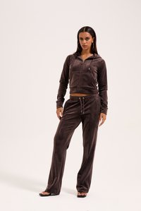 Brun velour zip-up hoodie og matchende bukser sæt. Har et tætsiddende design, forlommer og snøre i taljen. Glat tekstur.