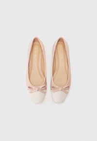 Ballet flats in soft pink patent material with a white patent cap toe and a bow accent at the front. Smooth texture throughout.