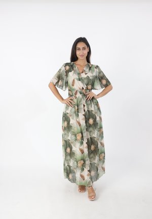 Robe longue et fluide en tissu léger et transparent avec un motif floral. Elle possède des manches courtes, un décolleté en V et une taille élastique.