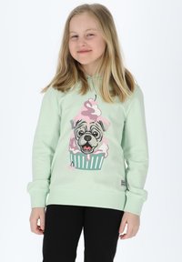 Felpa verde menta con un disegno di un bulldog francese in stile cartone animato e un cupcake di gelato, pantaloni neri e polsini a coste. Tessuto morbido, vestibilità casual.
