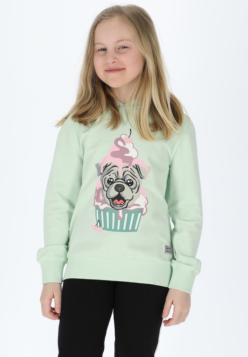 Felpa verde menta con un disegno di un bulldog francese in stile cartone animato e un cupcake di gelato, pantaloni neri e polsini a coste. Tessuto morbido, vestibilità casual.