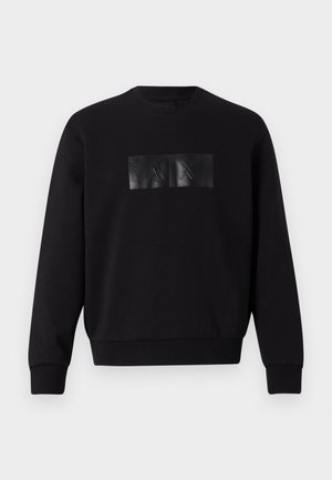 Black sweatshirt with a rectangular, glossy black logo patch featuring embossed letters "A" and "X" on the front. Cotton material, ribbed cuffs.