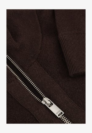 Brown sweater with ribbed collar and cuffs. Features a silver zipper with teeth design, soft texture, and a smooth, knitted fabric finish.