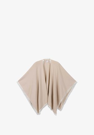 Beige poncho met witte franjes aan de randen, open voorkant en een losvallende pasvorm, geschikt om over kleding te dragen.