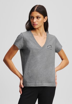 Gray v-neck t-shirt made of soft fabric, featuring short sleeves and a small branded logo on the left chest. Simple, relaxed fit design.