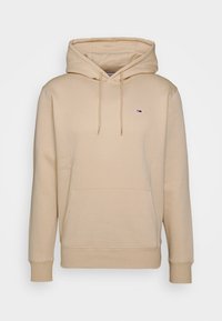 Beige mikina s kapucí vyroben�á z měkké tkaniny, s přední kapsou, žebrovanými manžetami a malým logem na hrudi.