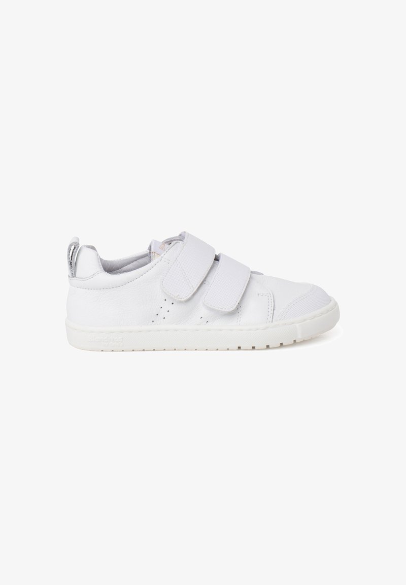 White leather sneaker with two Velcro straps, perforated details on the sides, and a textured rubber sole. Smooth finish and rounded toe.