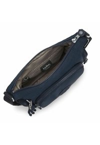 Navy blue zippered pouch with fabric exterior, featuring a light-colored interior, a logo patch, and a keychain accessory for easy carrying.