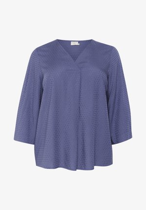 V-neck, three-quarter sleeve top in textured blue fabric with small holes, offering a relaxed fit and soft drape.