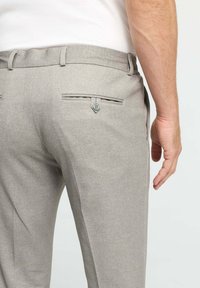 Light gray trousers with a textured finish, featuring a single back pocket with a button closure and a belt loop waistband.