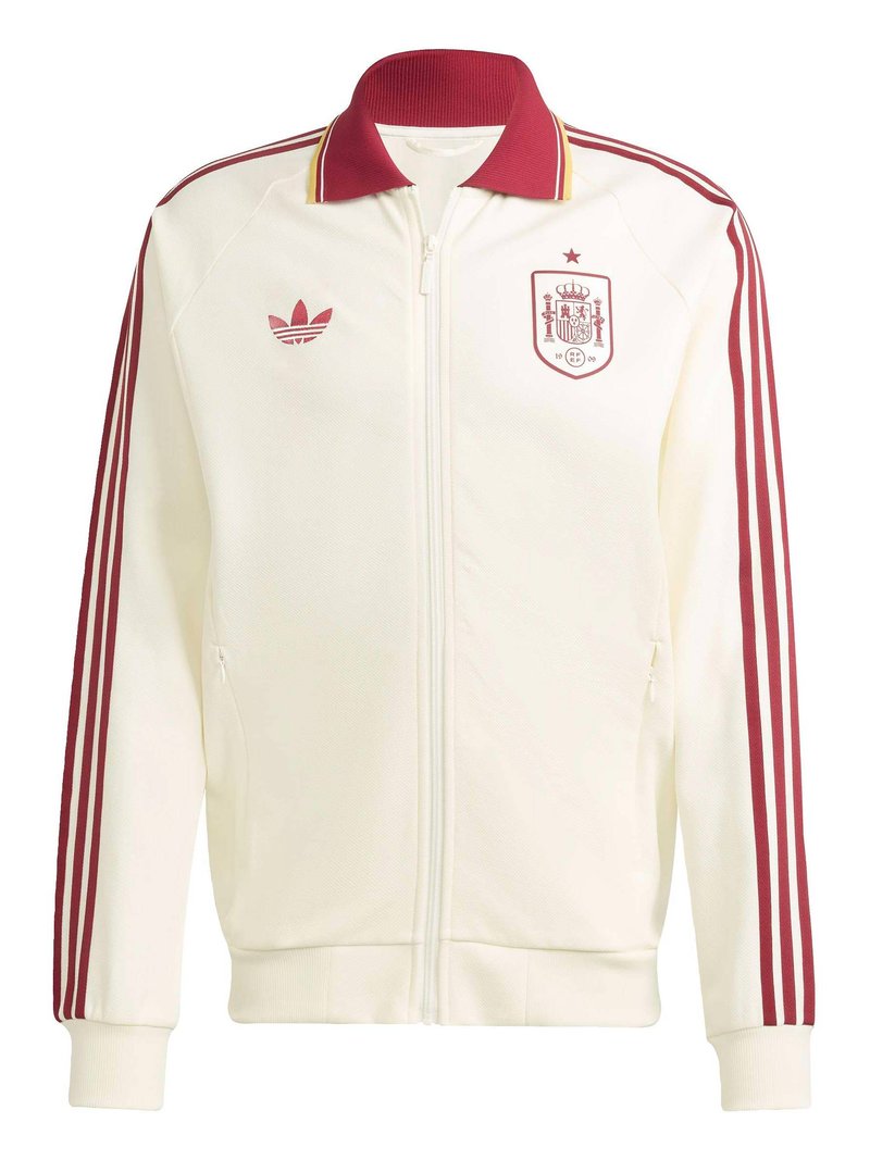 Veste de sport blanche à fermeture éclair avec des bandes rouges sur les manches, un col rouge, le logo Adidas sur la poitrine gauche et l'emblème national d'Espagne sur la poitrine droite.