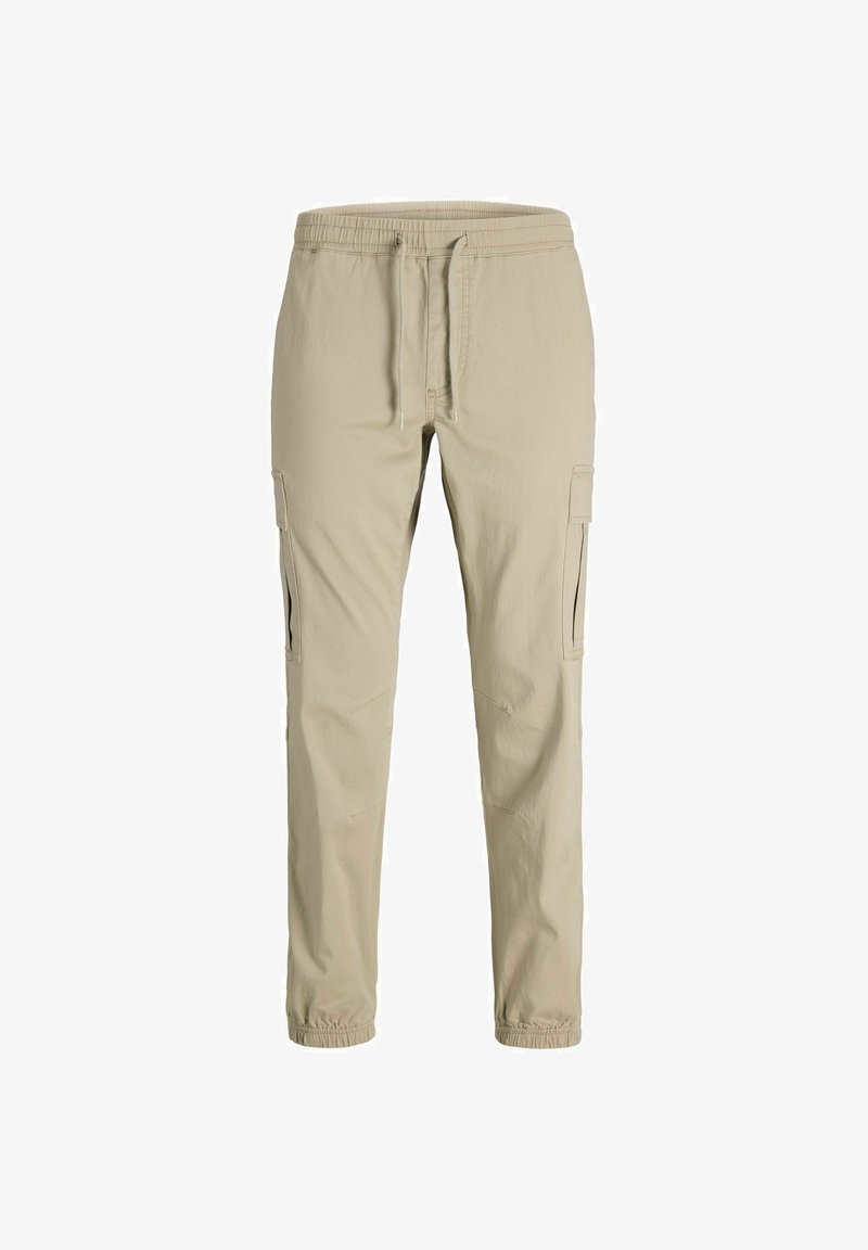 Pantalon cargo beige slim fit avec taille élastique, cordon de serrage, poches latérales et poignets élastiques.