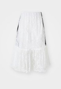 White lace skirt with a tiered design, featuring a scalloped hem and black side accents. Textured fabric with a floral pattern.