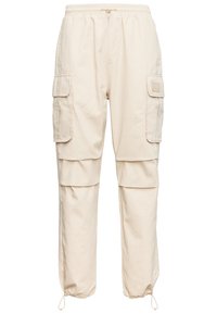 Beiga cargobyxor med elastisk midja, två sidofickor och dragsko i vristerna. Tillverkade av slitstarkt tyg med en avslappnad passform.