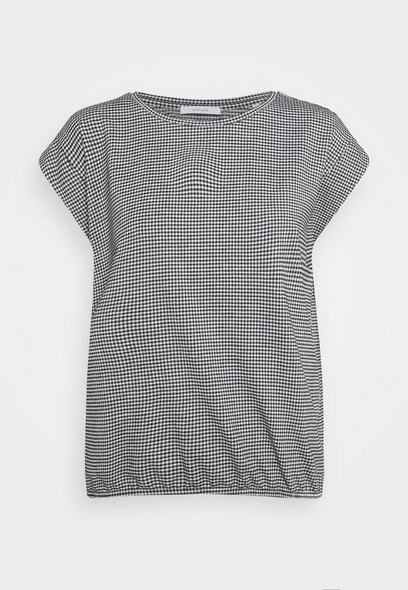 Haut à carreaux noir et blanc avec un col rond, des manches courtes et un ourlet froncé. Fait en tissu doux et texturé.