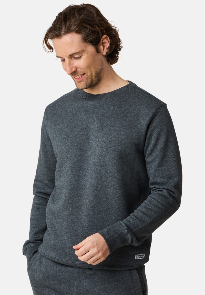 Gray crewneck sweatshirt made of cotton blend fabric. Featured ribbed cuffs, a relaxed fit, and a small label on the lower hem.