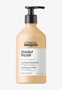 L'Oréal Professionnel-schampo i en genomskinlig, rundad bärnstensfärgad flaska. Har en svart pump, vit etikett med text och en kapacitet på 500 ml.