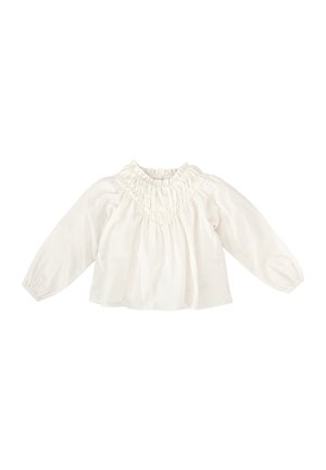 Blusa blanca de manga larga hecha de una tela ligera, con un cuello con volantes y rayas verticales texturizadas. Silueta holgada.