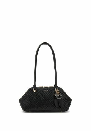 Sac à main noir matelassé avec double poignées, ferrures dorées et breloque décorative avec le logo "G", marqué GUESS EST 1981 à l'avant.