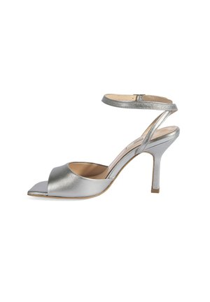 Silver metallic high-heeled sandal with open toe, ankle strap, and a slender heel. Smooth texture with a shiny finish. Square toe design.