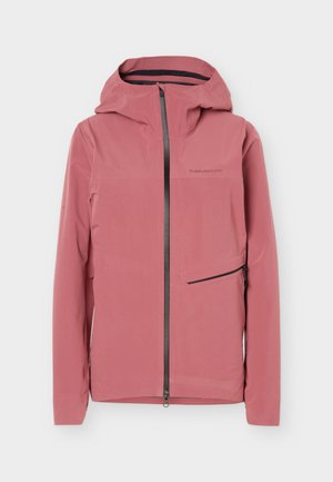 Φόρμα με κουκούλα σε χρώμα ξεθωριασμένο ροζ με φερμουάρ σε όλο το μήκος μπροστά, μία πλαγιαστή τσέπη με φερμουάρ στη δεξιά πλευρά και διακριτικό λογότυπο στο στήθος.