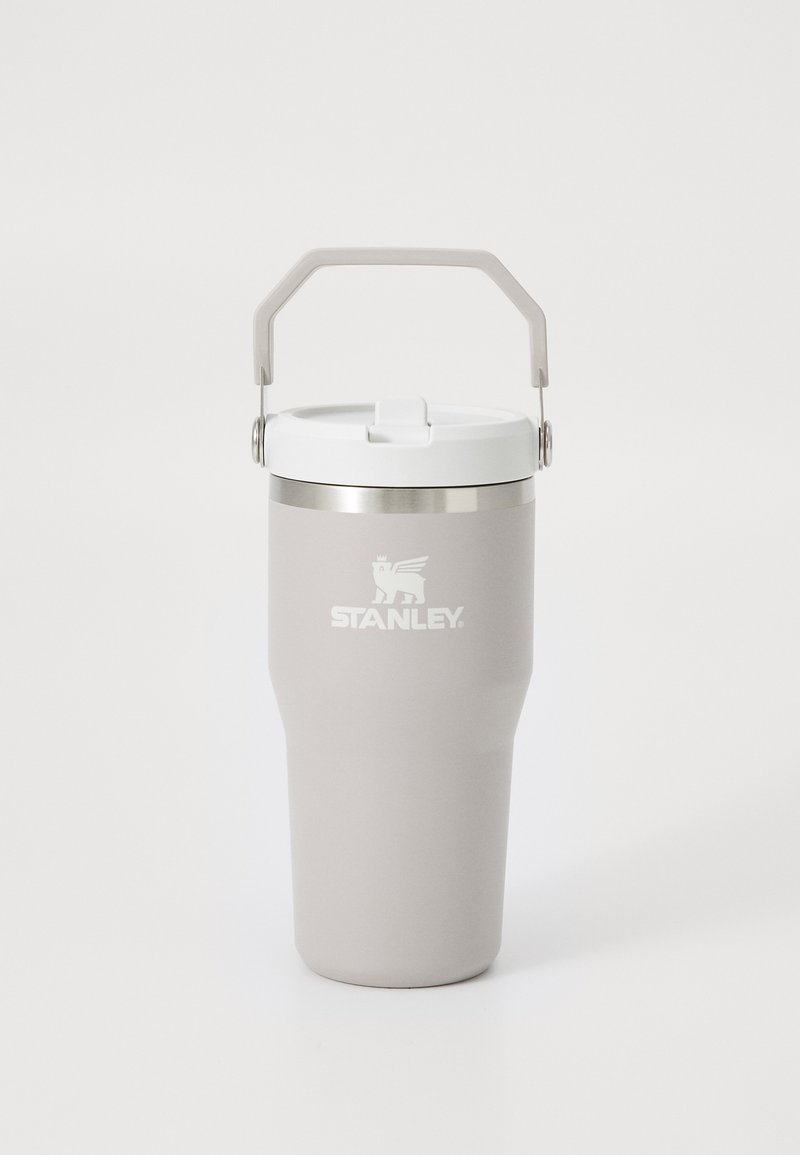 Gray stainless steel tumbler with a white lid and a matching handle. Features a textured surface and the "STANLEY" logo in white.