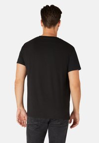 Black short-sleeve t-shirt made of cotton, featuring a round neckline and a standard fit. Back view shows minimal detailing, no graphics.