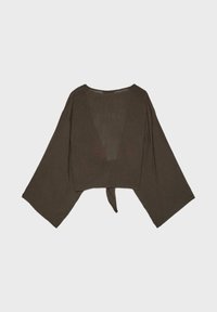 Blouse courte vert olive foncé avec de larges manches longues et un détail noué dans le dos, présentée à plat sur un fond clair.